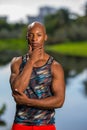 Portrait of handsome man posing with hand under chin. African American athletic person with a tank top shirt Royalty Free Stock Photo