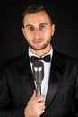 Portrait of handsome man sing on microphone on black background. Royalty Free Stock Photo