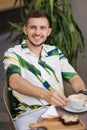 Portrait of handsome man sitting in cafe and drinking cappuccino. Young man Royalty Free Stock Photo
