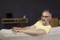 Portrait of handsome man wearing glasses at home sitting on sofa Royalty Free Stock Photo