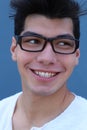 Portrait of handsome man wearing optical glasses isolated on blue. Young stylish Caucasian male model posing in studio Royalty Free Stock Photo