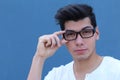 Portrait of handsome man wearing optical glasses isolated on blue. Young stylish Caucasian male model posing in studio Royalty Free Stock Photo