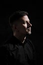 Portrait of a handsome man 40 years old on a dark artistic background close-up. Brunette, with gray hair, black beard Royalty Free Stock Photo