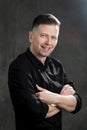 Portrait of a handsome man 40 years old on a dark artistic background close-up. Brunette, with gray hair, black beard Royalty Free Stock Photo