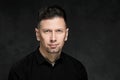 Portrait of a handsome man 40 years old on a dark artistic background close-up. Brunette, with gray hair, black beard Royalty Free Stock Photo