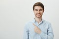 Portrait of handsome mature caucasian male entrepreneur pointing left with index finger while looking with confident Royalty Free Stock Photo