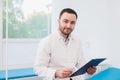 Portrait of handsome mature doctor in office Royalty Free Stock Photo