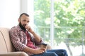 Portrait of handsome mature man with coffee on sofa Royalty Free Stock Photo