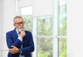 Portrait of handsome mature man in elegant suit with glasses Royalty Free Stock Photo