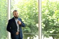 Portrait of handsome mature man in elegant suit near window Royalty Free Stock Photo