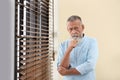 Portrait of handsome mature man with blinds Royalty Free Stock Photo