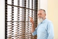 Portrait of handsome mature man near window Royalty Free Stock Photo