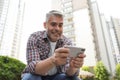 Portrait of handsome mature man using mobile phone Royalty Free Stock Photo