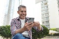Portrait of handsome mature man using mobile phone Royalty Free Stock Photo