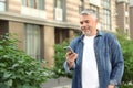Portrait of handsome mature man using mobile phone in city Royalty Free Stock Photo