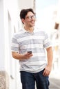 Handsome mature man walking with cell phone in the city Royalty Free Stock Photo