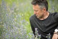 Portrait of handsome mid-adult man posing on summer meadow