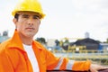 Portrait of handsome mid adult man wearing protective workwear at construction site Royalty Free Stock Photo