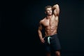 Portrait of a handsome muscular bodybuilder in hoodie posing ove