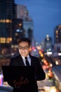 Handsome Persian businessman against view of the city at night Royalty Free Stock Photo