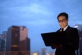 Handsome Persian businessman against view of the city at night Royalty Free Stock Photo