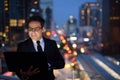 Handsome Persian businessman against view of the city at night Royalty Free Stock Photo