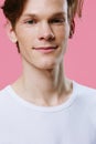 portrait of a handsome, red-haired, attractive guy with freckles on his face, looking at the camera with a slight smile Royalty Free Stock Photo