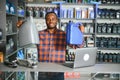 Portrait of a handsome african salesman in an auto parts store. The concept of car repair Royalty Free Stock Photo