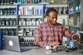 Portrait of a handsome african salesman in an auto parts store. The concept of car repair Royalty Free Stock Photo