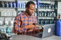 Portrait of a handsome african salesman in an auto parts store. The concept of car repair Royalty Free Stock Photo