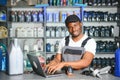 Portrait of a handsome african salesman in an auto parts store. The concept of car repair Royalty Free Stock Photo