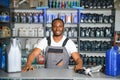 Portrait of a handsome african salesman in an auto parts store. The concept of car repair Royalty Free Stock Photo