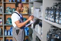 Portrait of a handsome african salesman in an auto parts store. The concept of car repair Royalty Free Stock Photo