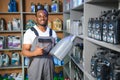 Portrait of a handsome african salesman in an auto parts store. The concept of car repair Royalty Free Stock Photo