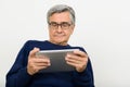 Portrait of handsome senior man with eyeglasses using digital tablet Royalty Free Stock Photo