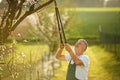 Portrait of a handsome senior man gardening in his garden Royalty Free Stock Photo