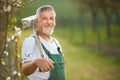 Portrait of a handsome senior man gardening in his garden Royalty Free Stock Photo