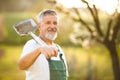 Portrait of a handsome senior man gardening in his garden Royalty Free Stock Photo