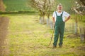 Portrait of a handsome senior man gardening in his garden Royalty Free Stock Photo