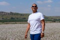 Portrait Of Handsome Senior Man In Outdoors. Sporty athletic elderly man on background of sky and cotton field. Royalty Free Stock Photo