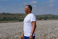 Portrait Of Handsome Senior Man In Outdoors. Sporty athletic elderly man on background of sky and cotton field. Royalty Free Stock Photo