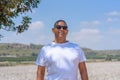 Portrait Of Handsome Senior Man In Outdoors. Sporty athletic elderly man on background of sky and cotton field. Royalty Free Stock Photo