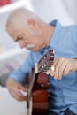 Portrait handsome senior man playing acoustic guitar Royalty Free Stock Photo