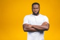 Portrait of handsome serious young african american man isolated yellow background Royalty Free Stock Photo