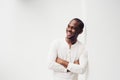 Handsome smiling African American man with arms crossed against white background Royalty Free Stock Photo