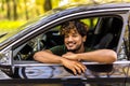 Portrait of an handsome smiling asian business man driving his car Royalty Free Stock Photo