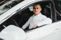 Portrait of an handsome smiling business man driving his car. Royalty Free Stock Photo