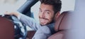 Portrait of an handsome smiling business man driving his car Royalty Free Stock Photo