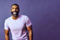 portrait of a handsome smiling man with beard and mustache purple shirt on a gray looking away at copy space background Royalty Free Stock Photo