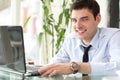 Portrait of handsome smiling man working laptop Royalty Free Stock Photo